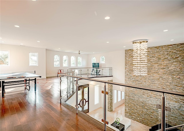 hallway featuring a chandelier and hardwood / wood-style flooring