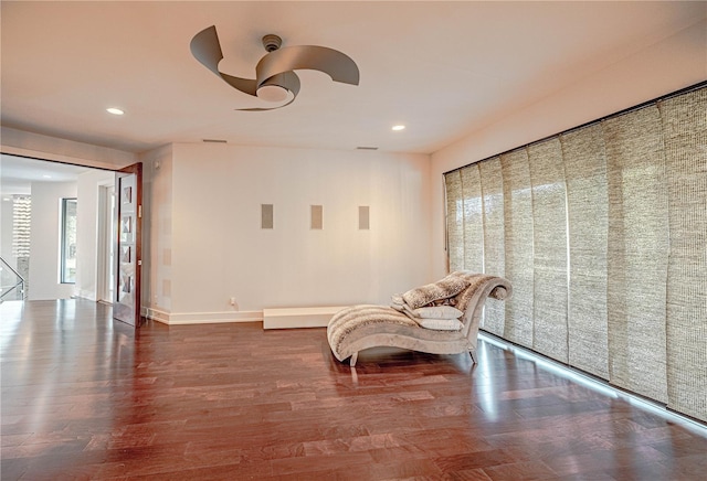 sitting room featuring ceiling fan and hardwood / wood-style flooring