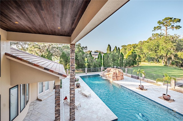 view of swimming pool featuring pool water feature and a patio