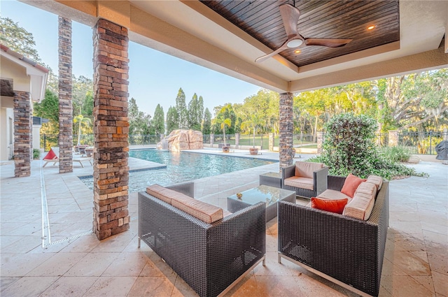 view of patio with pool water feature, ceiling fan, and outdoor lounge area