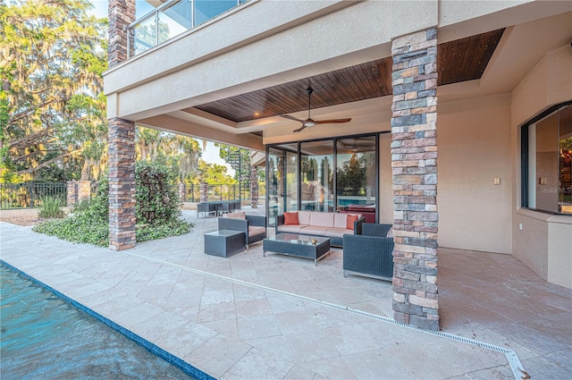 view of terrace with an outdoor living space and ceiling fan