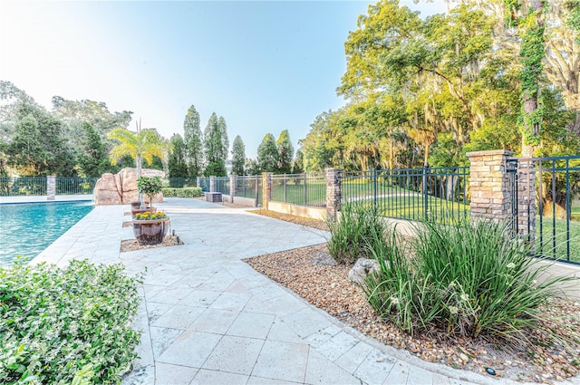 view of nearby features with a pool and a patio area