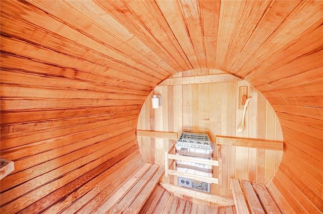 view of sauna with wooden ceiling and wood walls