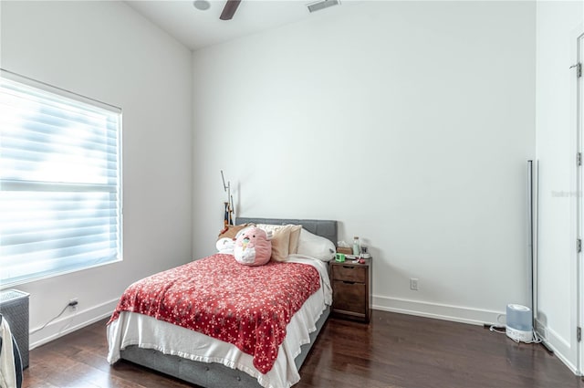 bedroom with ceiling fan and dark wood-type flooring