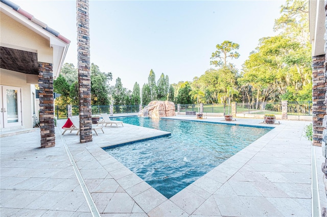 view of pool with a patio and pool water feature