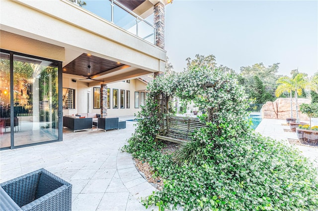 view of patio / terrace with an outdoor living space, ceiling fan, and a balcony