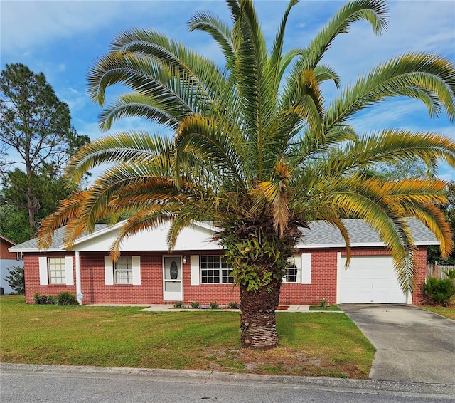 view of front of property with a garage and a front lawn