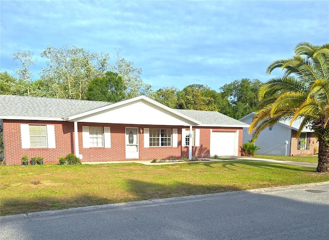 ranch-style house featuring a garage and a front yard