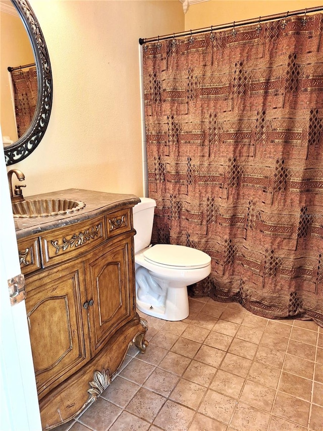 bathroom with tile flooring, vanity, and toilet