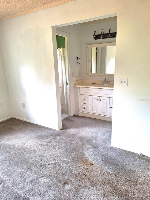 bathroom with crown molding, vanity, and a textured ceiling