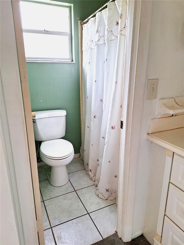 bathroom with toilet and tile flooring