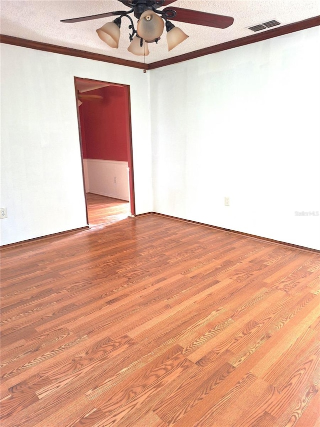 unfurnished room featuring a textured ceiling, hardwood / wood-style floors, and ceiling fan