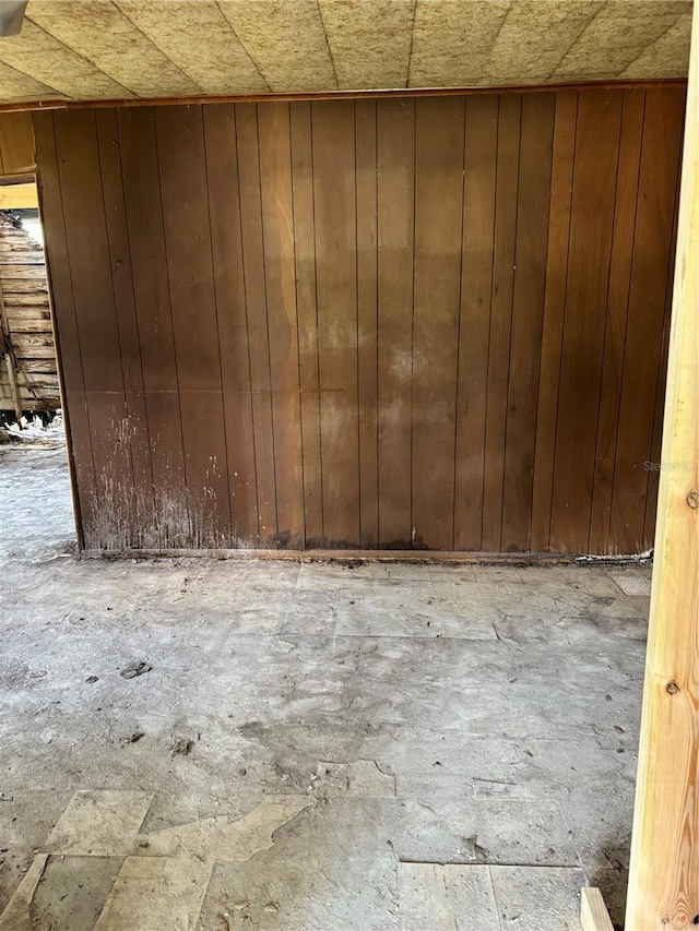 spare room featuring wooden walls