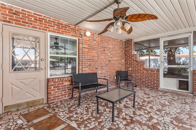 sunroom featuring ceiling fan and wooden ceiling