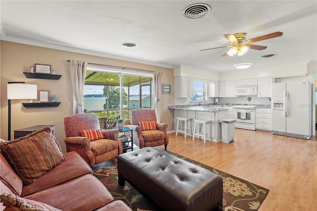 living room with sink, ceiling fan, light wood-type flooring, and ornamental molding