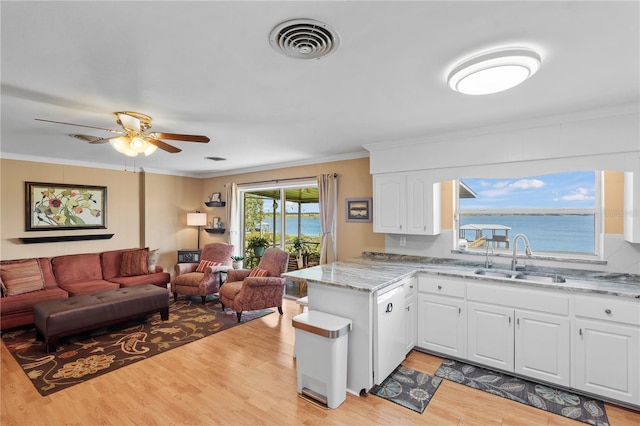 kitchen featuring ceiling fan, white cabinets, sink, light hardwood / wood-style floors, and kitchen peninsula