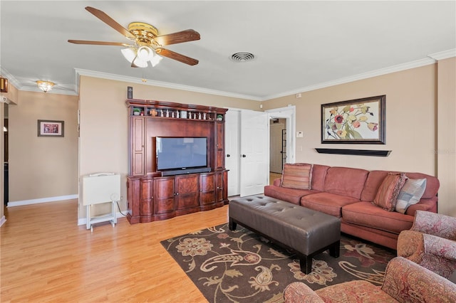 living room with hardwood / wood-style floors, ceiling fan, and ornamental molding