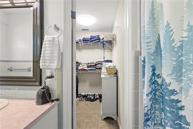 bathroom with tile flooring and vanity