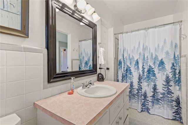 bathroom with vanity with extensive cabinet space and tile walls