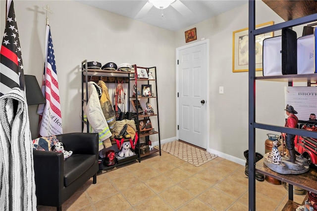 interior space with ceiling fan