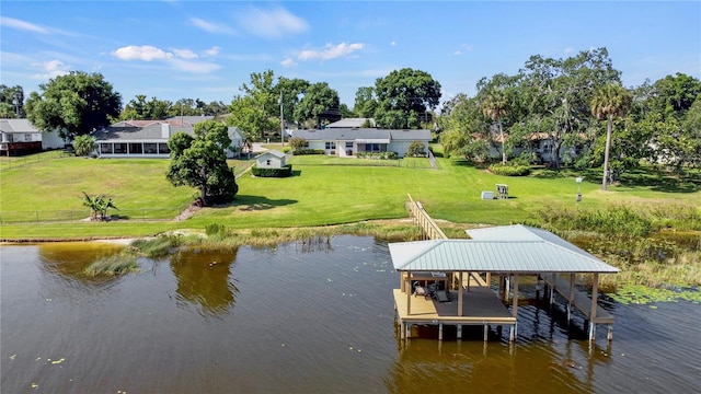 view of dock featuring a water view and a lawn