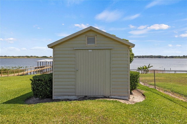 view of shed / structure featuring a water view and a lawn