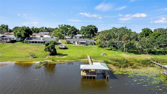 dock area with a water view and a lawn