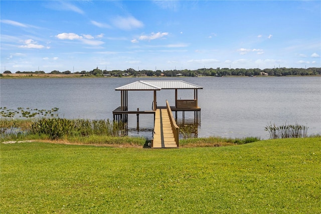 dock area with a water view and a lawn