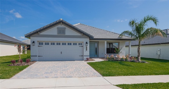 view of front of property with a garage and a front lawn