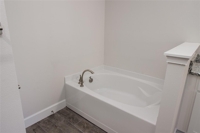 bathroom featuring wood-type flooring and a washtub