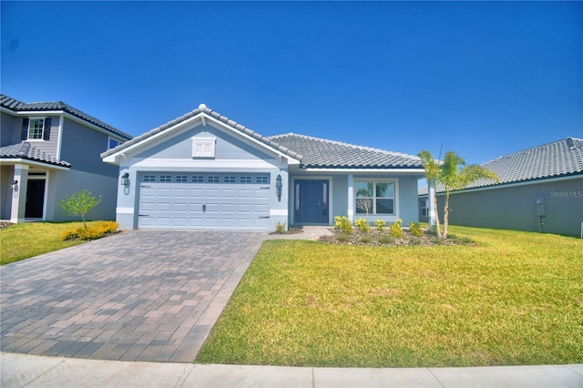 single story home featuring a front lawn, driveway, stucco siding, and a tiled roof