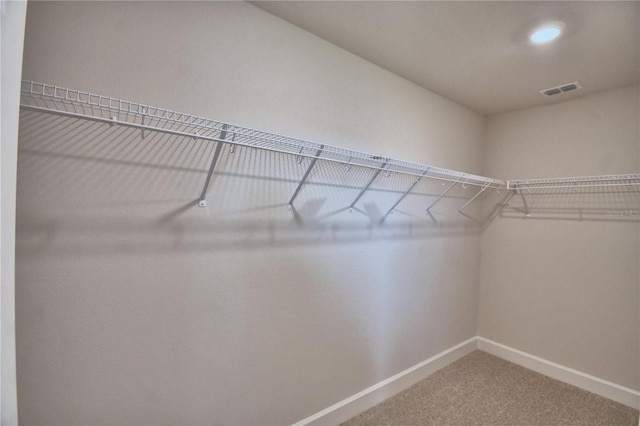 spacious closet featuring carpet floors and visible vents