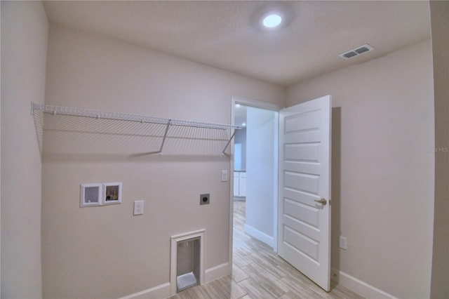 washroom featuring hookup for an electric dryer, laundry area, baseboards, visible vents, and hookup for a washing machine