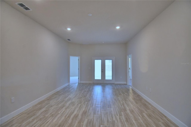 unfurnished room featuring recessed lighting, french doors, baseboards, visible vents, and light wood-style flooring