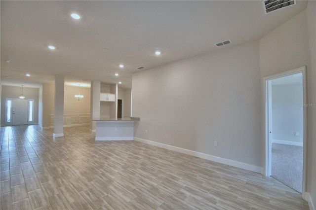 unfurnished living room featuring light wood-style flooring, visible vents, and recessed lighting