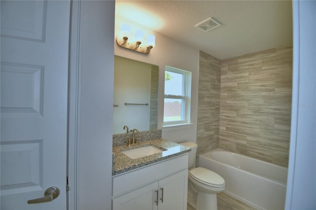 full bathroom featuring toilet, vanity, shower / bath combination, and visible vents