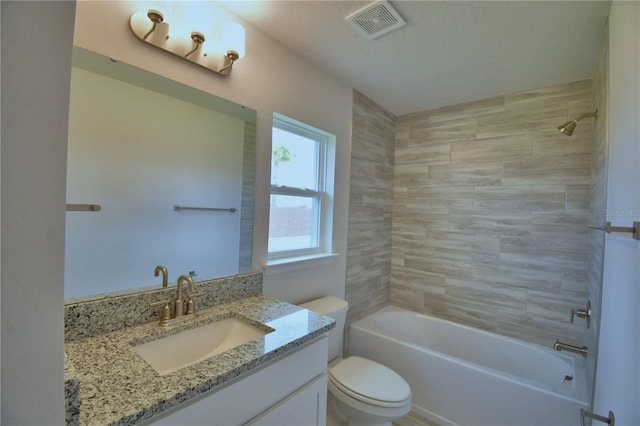 bathroom with toilet, vanity, tub / shower combination, and visible vents