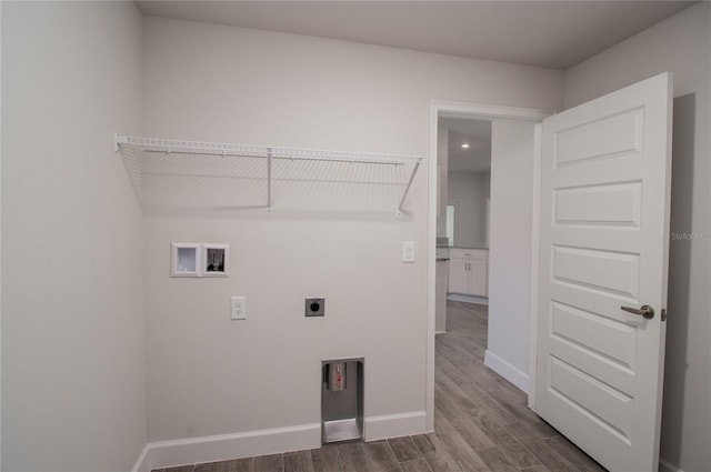 washroom with dark hardwood / wood-style floors, hookup for a washing machine, and electric dryer hookup