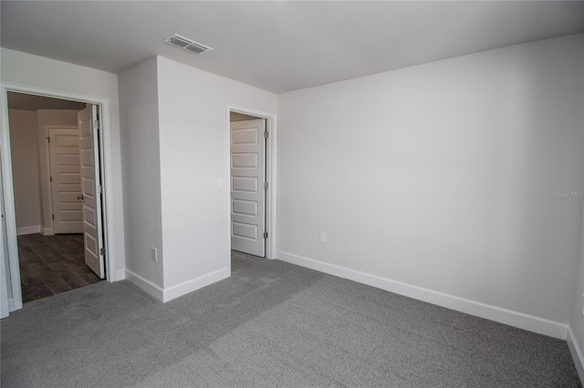 unfurnished bedroom with dark wood-type flooring