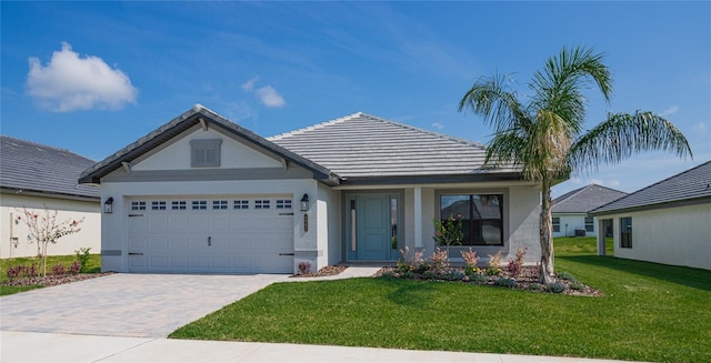 view of front of home featuring a garage and a front lawn