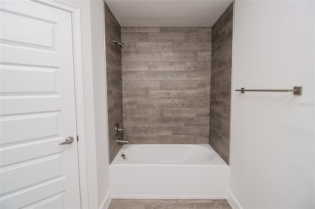 bathroom with tile flooring and tiled shower / bath