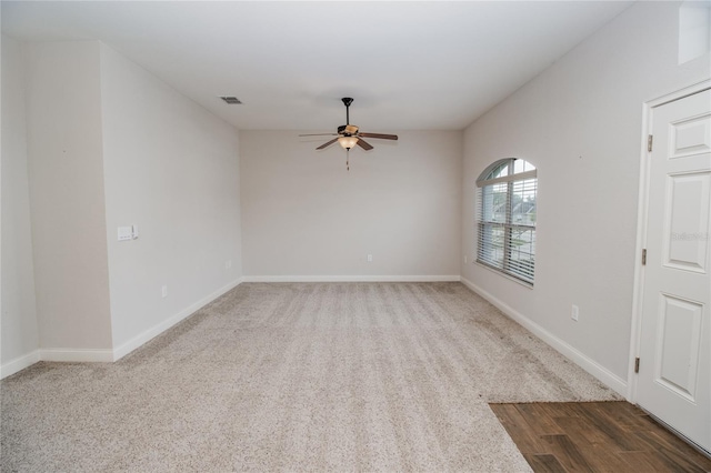 unfurnished room with ceiling fan and dark hardwood / wood-style flooring