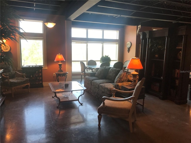 living room featuring plenty of natural light and concrete floors