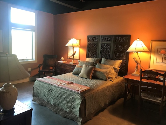 bedroom featuring concrete flooring