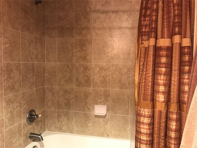 bathroom featuring shower / tub combo with curtain