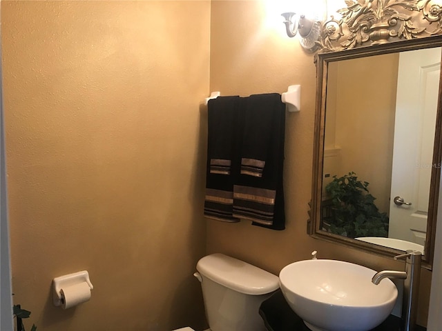 bathroom featuring sink and toilet