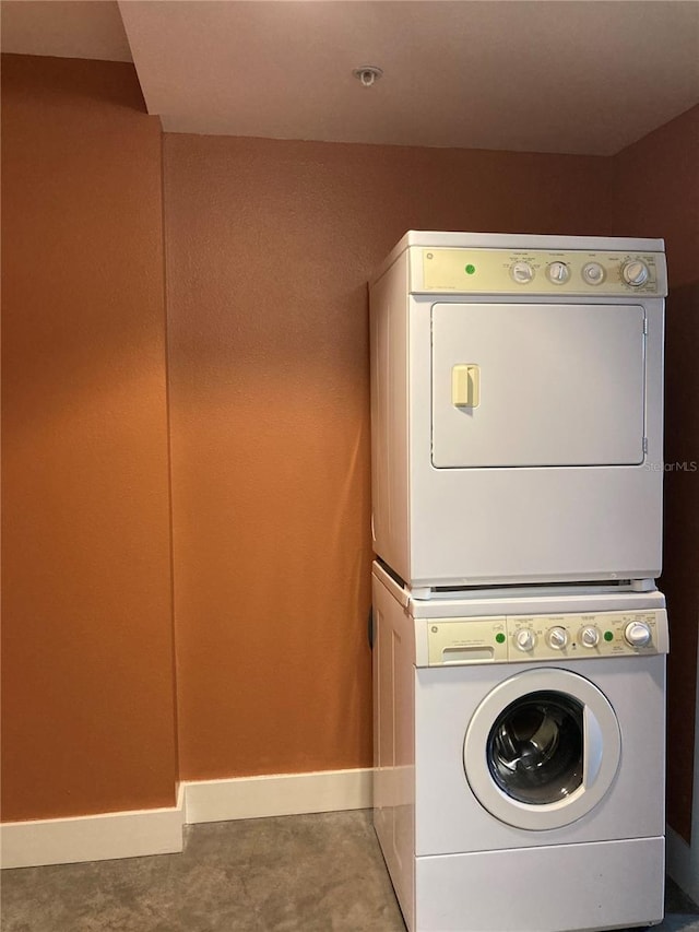 laundry room with stacked washer / drying machine