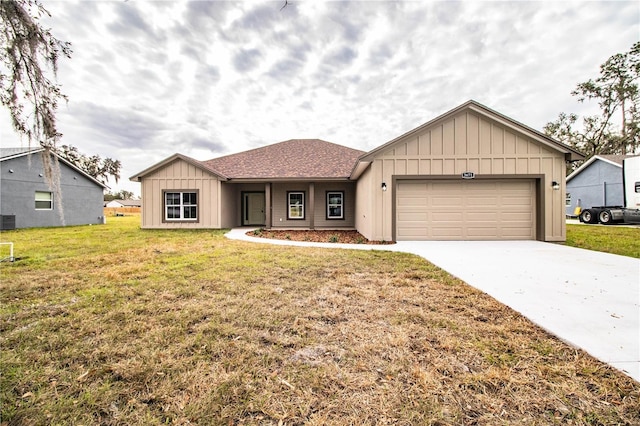 view of front facade with a garage, a front yard, and central AC