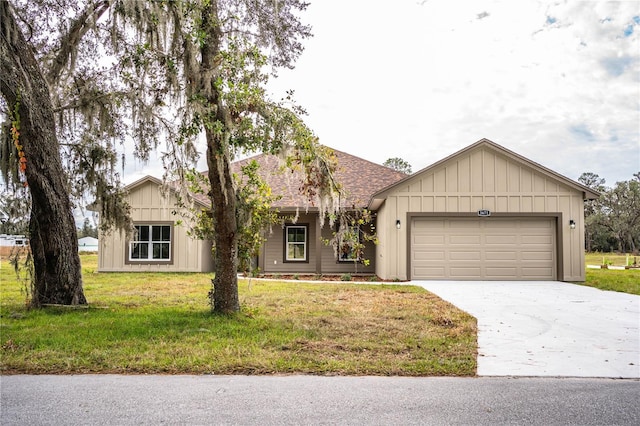 single story home featuring a garage and a front lawn