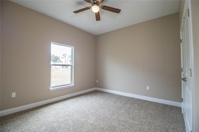 empty room featuring ceiling fan and carpet floors